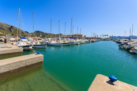POLLENCA PORT, MAJORCA - APR 15, 2013: traditional llaut boats anchored in port on sunny day on Majorca island.のeditorial素材