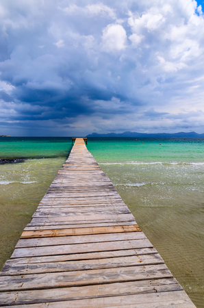 Wooden pier on Alcudia beach, Majorca island, Spainの写真素材