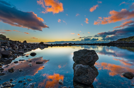Sunset over small sea bay with rocks, La Gomera island, Spainの写真素材