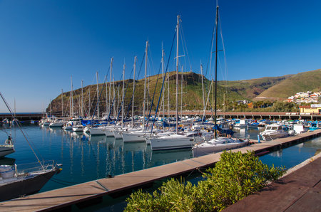 View of small port with sailing boats, San Sebastian, La Gomera island, Spainのeditorial素材