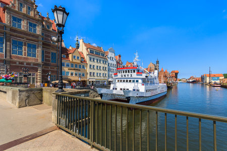GDANSK, POLAND - JUN 8, 2013: tourist boat on Motlawa river and old city houses in the background in...