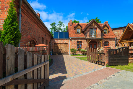 LEBA, POLAND - JUN 10, 2013: traditional house built from red bricks in coastal town of Leba. This town is very popular holiday destination for tourists in summer.のeditorial素材
