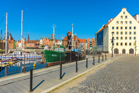 GDANSK, POLAND - JUN 8, 2013: boats and old city houses in the background in Gdansk port. Historic...