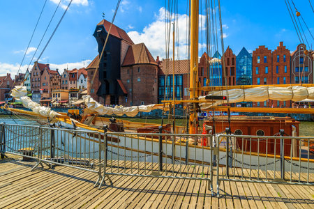 Yacht boat in Gdansk city port with famous wooden crane in background, Polandのeditorial素材