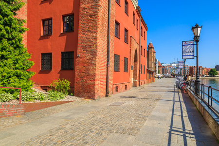 GDANSK, POLAND - JUN 8, 2013: shops and restaurants on riverside street of Gdansk port. Gdansk is a...