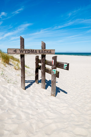 Wooden trail sign on beach in Slowinski National Park, Polandのeditorial素材