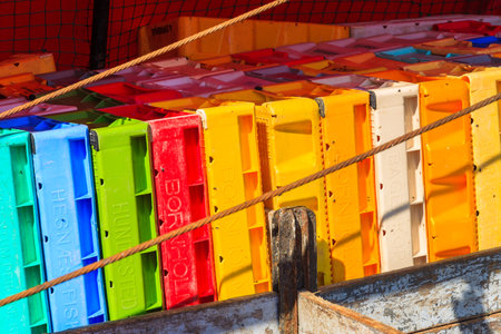 LEBA, POLAND - JUN 10, 2013: colourful stack of fish crates on vessel in Leba harbour. Leba is home town to many fishermen on Baltic Sea coast.のeditorial素材