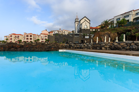 Hotel swimming pool at coast of Atlantic Ocean, Madeira island, Portugalの写真素材