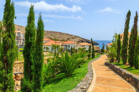 MADEIRA ISLAND, PORTUGAL - AUG 27, 2013: alley in gardens of luxury hotel on coast of Atlantic Ocean. Madeira island is famous for best hotels in Portugal and for climate of eternal spring.のeditorial素材