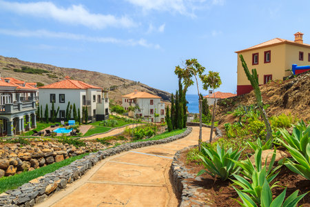 MADEIRA ISLAND, PORTUGAL - AUG 27, 2013: alley in gardens of luxury hotel on coast of Atlantic Ocean. Madeira island is famous for best hotels in Portugal and for climate of eternal spring.のeditorial素材
