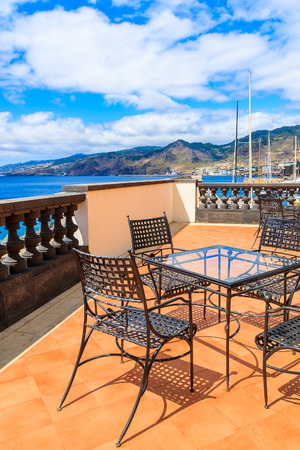 Table on terrace in sailing port on coast of Madeira island, Portugalの写真素材