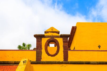 Yellow colour facade of old fortress Sao Tiago in Funchal town, Madeira island, Portugalの写真素材