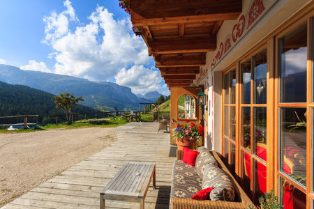 SAN CASSIANO, DOLOMITES, ITALY - SEP 25, 2013: sunny patio of alpine luxury hotel in San Cassiano village, Italy.のeditorial素材
