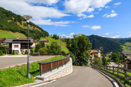 Road in alpine village on sunny summer day, Colfosco, The Dolomites Mountains, Italyのeditorial素材