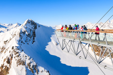 SOLDEN SKI RESORT, AUSTRIA - JAN 29, 2018: Skiers looking at mountains from platform in Solden ski area on beautiful sunny winter day, Tirol, Austria.のeditorial素材