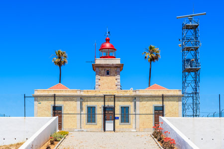View of lighthouse near Cabo de Sao Vicente on coast of Atlantic Ocean, Algarve region, Portugalのeditorial素材