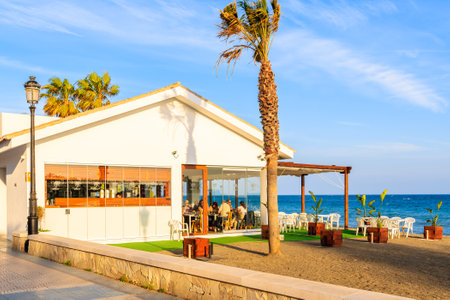 MARBELLA TOWN, SPAIN - MAY 9, 2018: People dining in beach restaurant on Cost del Sol coast in Marbella town. Spain is second most visited by tourists country in Europe.のeditorial素材