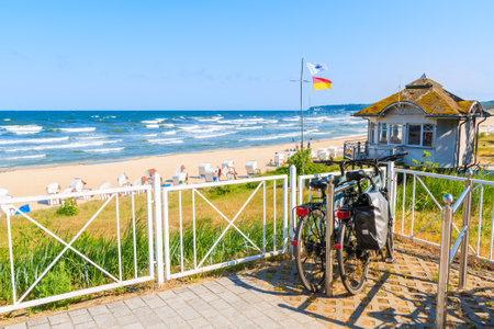 SELLIN, RUEGEN ISLAND - MAY 29, 2018: Bicycle parked terrace overlooking beach in Sellin town on Baltic Sea coast, Germany. Ruegen is popular tourist destination because of its long sandy beaches.のeditorial素材