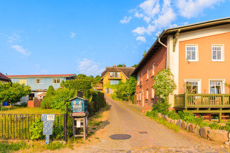 SEEDORF PORT, RUEGEN ISLAND - JUN 2, 2018: Traditional houses on street in Seedorf village on sunny beautiful day. Ruegen is popular tourist destination because of its resort architecture.のeditorial素材