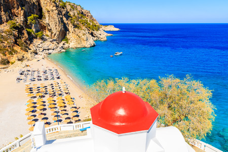 View of Kyra Pynagia beach and Greek chapel on hill top, Karpathos island, Greeceの写真素材