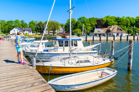 KLOSTER PORT, HIDDENSEE ISLAND - MAY 30, 2018: Sailing boats anchoring in yacht port on sunny...