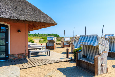 LOBBE VILLAGE, RUEGEN ISLAND - MAY 31, 2018: Restaurant with traditional beach chairs in outside area on Baltic Sea coast, Germany. Rugen is popular tourist destination due to its long sandy beaches.のeditorial素材