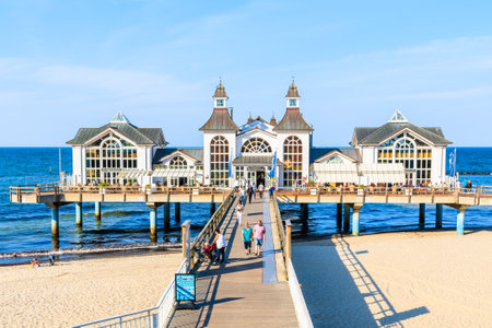 RUGEN ISLAND, GERMANY - MAY 28, 2018: Wooden pier on sandy beach and famous Sellin Seebruecke (Sellin Pier) in summer, Ostseebad Sellin tourist resort, Baltic Sea, Germany.のeditorial素材