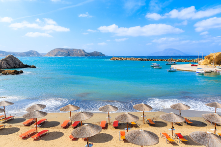 Umbrellas and sunbeds on beautiful Finiki beach, Karpathos island, Greeceの写真素材