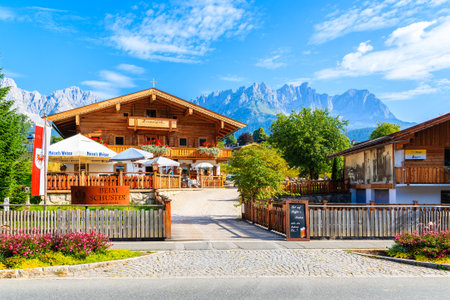 TIROL, AUSTRIA - JUL 29, 2018: Restaurant in typical alpine house in beautiful alpine village of Going am Wilden Kaiser on sunny summer day, Tirol, Austria.のeditorial素材