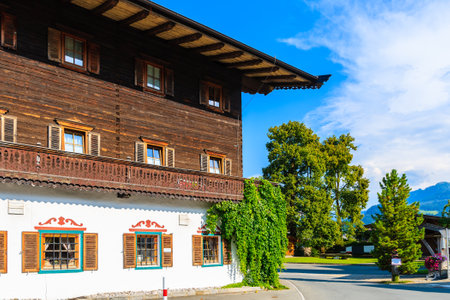 Typical alpine house in countryside landscape near Kitzbuhel town, Tirol, Austriaのeditorial素材