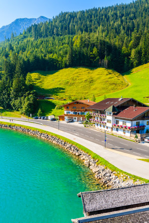 Shore of beautiful Achensee lake with houses on sunny summer day with blue sky, Karwendel mountain range, Tyrol, Austriaのeditorial素材