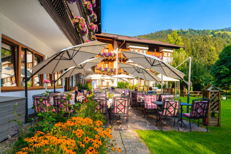 Outdoor restaurant garden area in small alpine village near Kitzbuhel town, Tirol, Austriaのeditorial素材