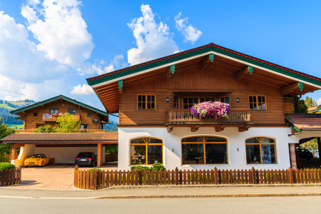 Typical alpine houses in countryside landscape near Kitzbuhel town, Tirol, Austriaのeditorial素材