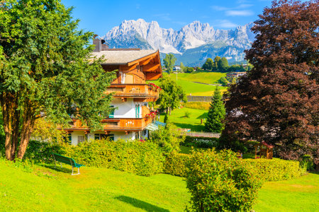 Traditional alpine house in village of Going am Wilden Kaiser with Alps Mountains in background, Tirol, Austriaのeditorial素材