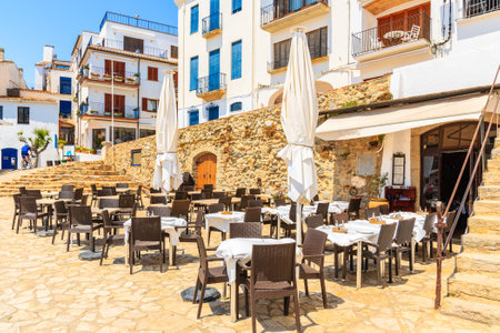 Restaurant tables in port Bo of Calella de Palafrugell, Costa Brava, Catalonia, Spainのeditorial素材