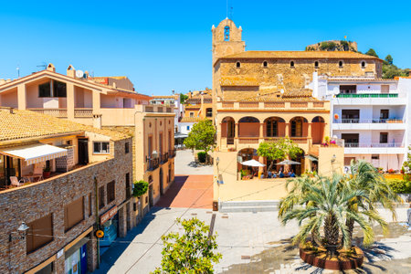 BEGUR, SPAIN - JUN 2, 2019: View of town square with church in Begur old town, Costa Brava, Spain. This place is famous for its medieval style architecture.のeditorial素材
