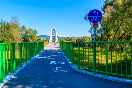 VELO DUNAJEC CYCLING PATH, POLAND - SEP 15, 2019: View of bridge over Dunajec river near Nowy Sacz and sign post marking the route, Poland.のeditorial素材