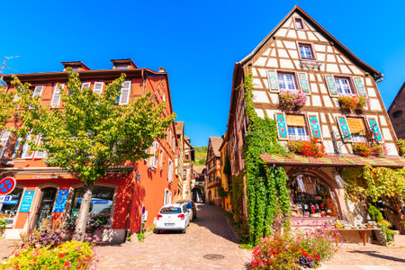 ALSACE WINE REGION, FRANCE - SEP 20, 2019: Street with typical houses and restaurant in Kaysersberg picturesque village which is located on Alsatian Wine Route, France.のeditorial素材