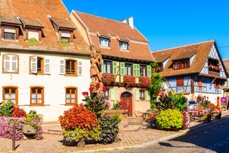 KINTZHEIM VILLAGE, FRANCE - SEP 19, 2019: Colorful houses decorated with flowers on street in beautiful old village of Kintzheim which is located on famous Alsace wine route, France.のeditorial素材