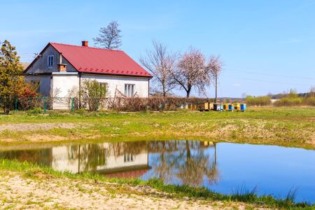 Typical house with beehives and small pond in rural area near Puszcza Niepolomicka near Krakow city, Polandの写真素材