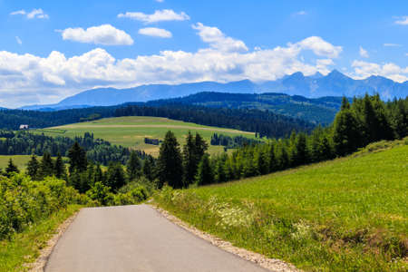 Cycling road from Kacwin to Lapsze Nizne village in Tatra Mountains on beautiful summer sunny day, Polandの写真素材
