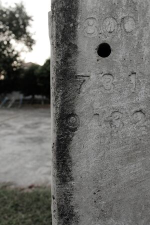 Closeup of electric concrete pole beside toy kid park.の写真素材