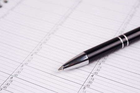 closeup macro photo of a ballpoint pen on a calendar page
