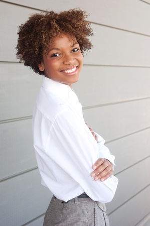 pretty African American executive standing outside with arms foldedの写真素材