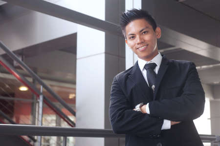 portrait of a young happy asian businessmanの写真素材