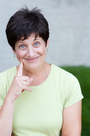 portrait of a mature woman standing outsideの写真素材