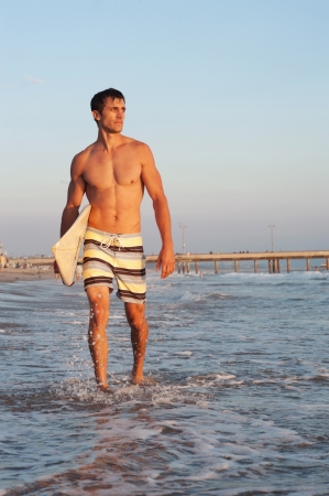 portrait of a surfer on the beach with surfboardの写真素材