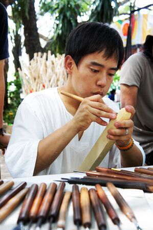 Ubon Ratchathani, Thailand - July 28, 2012 - The Artist of Ubon Wax Festival 2012 "Tanaka" Artist from Japan was carving wood in Ubon Wax Festival 2012               のeditorial素材
