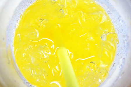 Orange plastic glass with tubuleの写真素材
