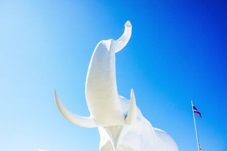 Elephant statue and Thai flag